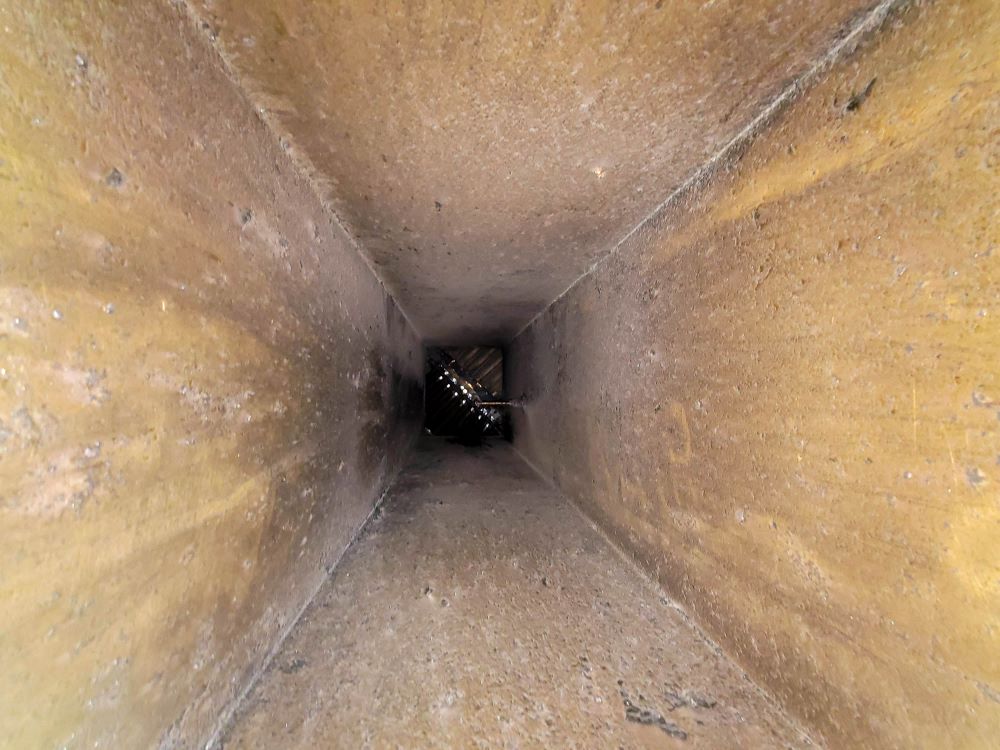 Interior view of an HVAC air duct during inspection for cleaning and improved airflow efficiency.